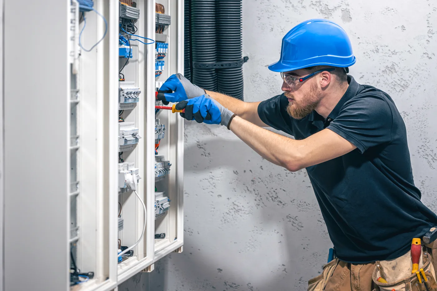 Técnico de reparación de ascensores trabajando en cuadro eléctrico en Vigo